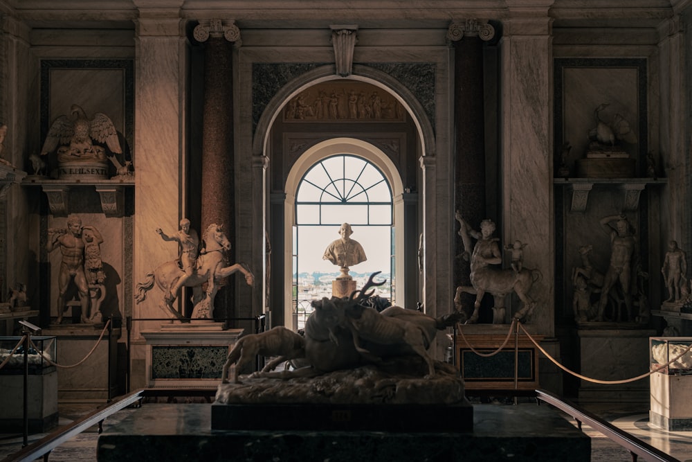 a statue of a man standing in front of a window