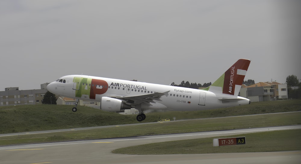 a large passenger jet taking off from an airport runway