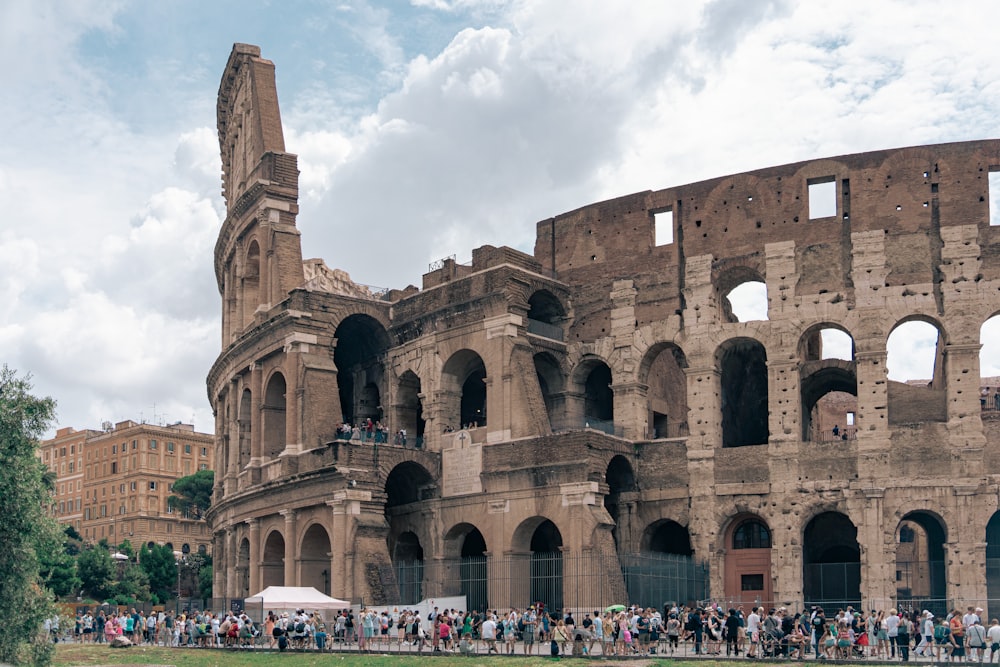 a group of people standing in front of an old building