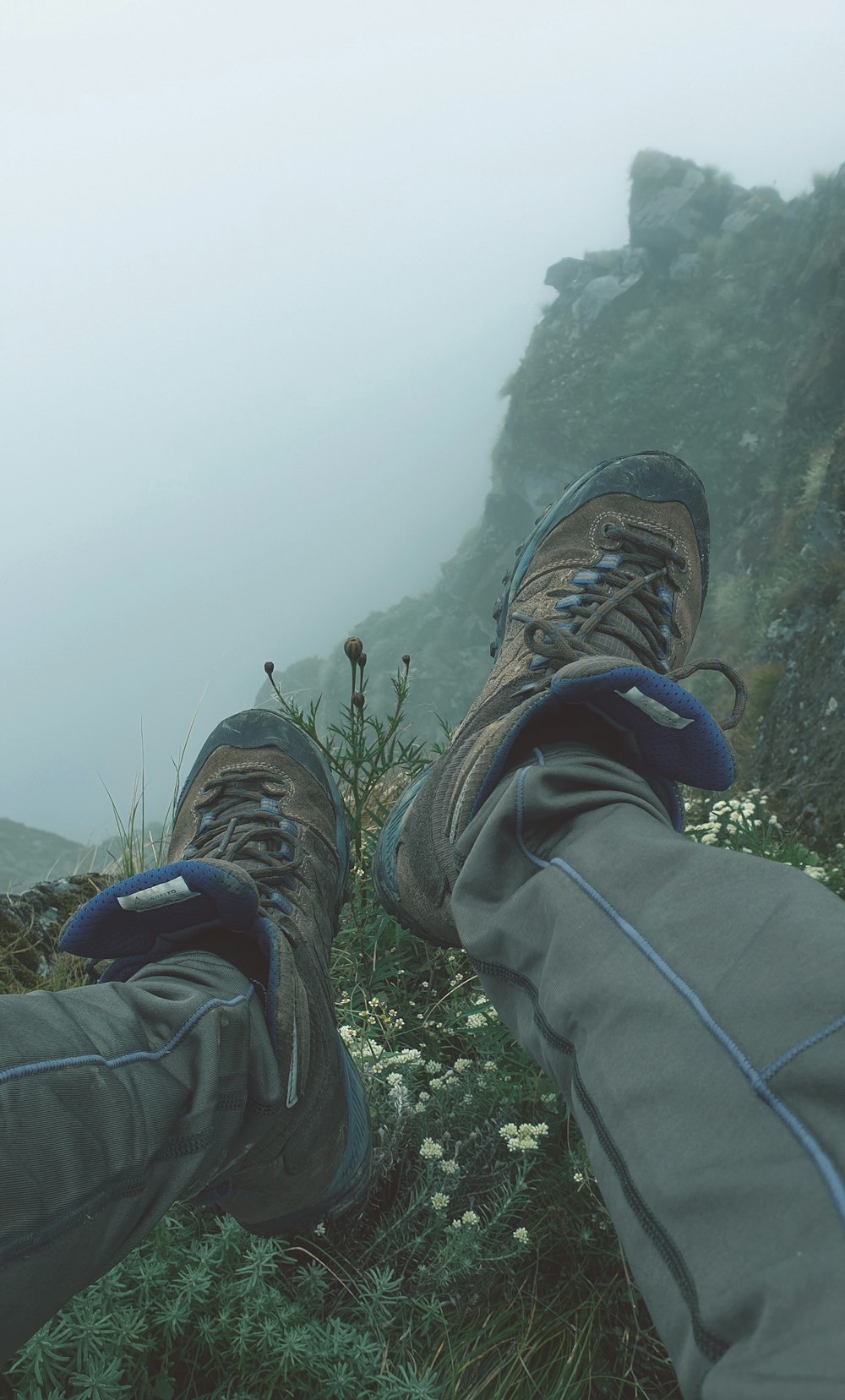 a pair of feet with hiking gear on a foggy day