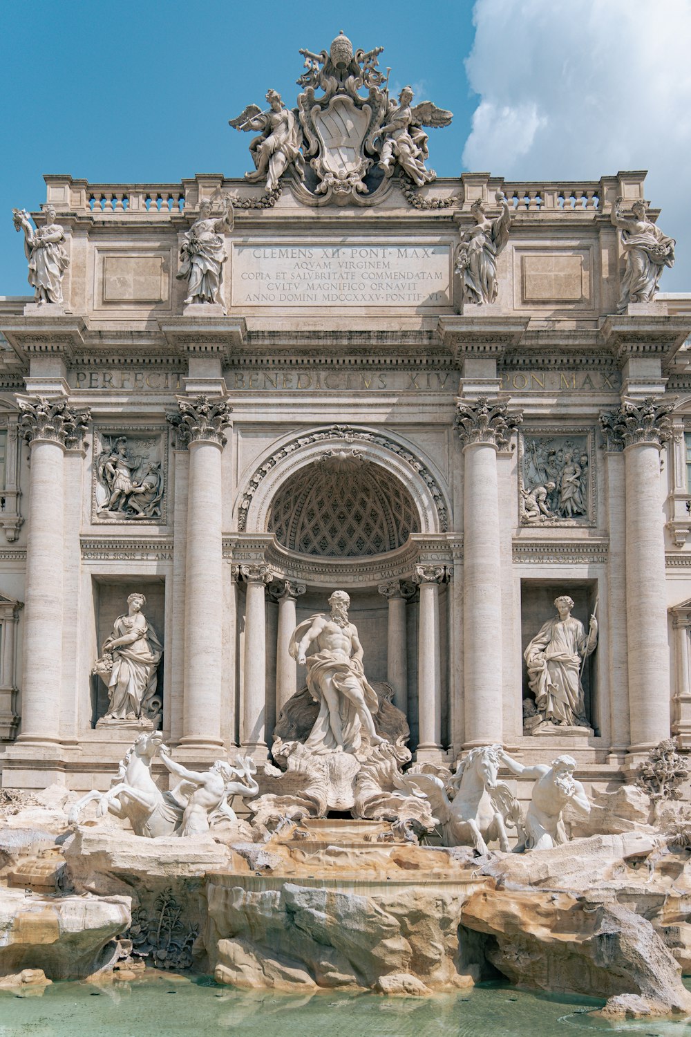 a large building with a fountain in front of it