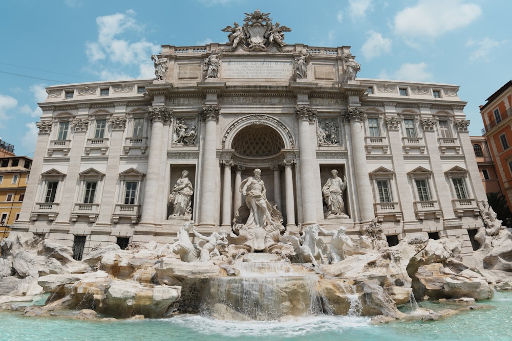 a large building with a fountain in front of it