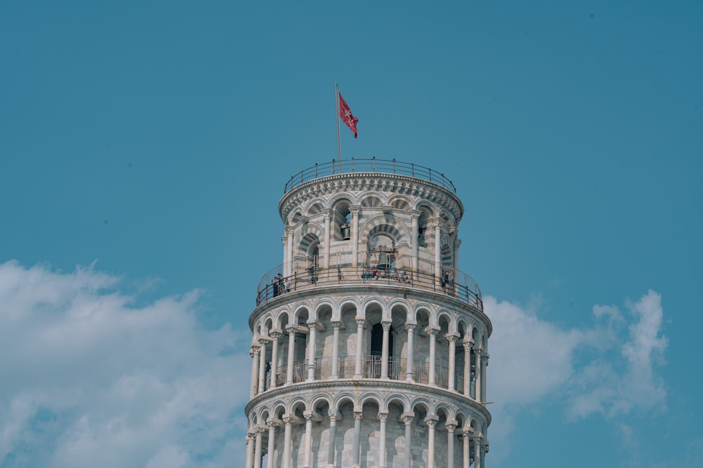 a tall tower with a flag on top of it