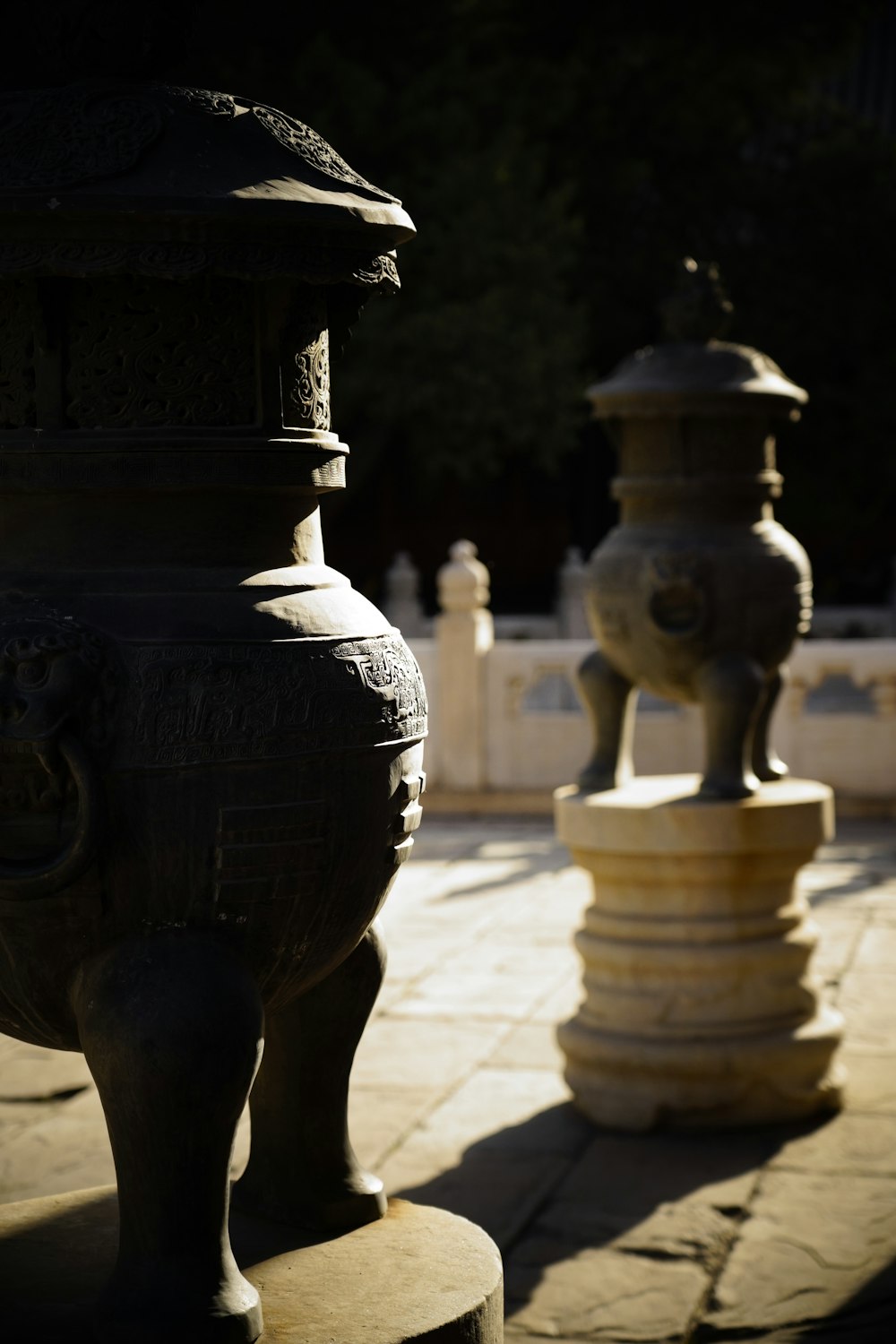 a couple of vases sitting on top of a stone walkway