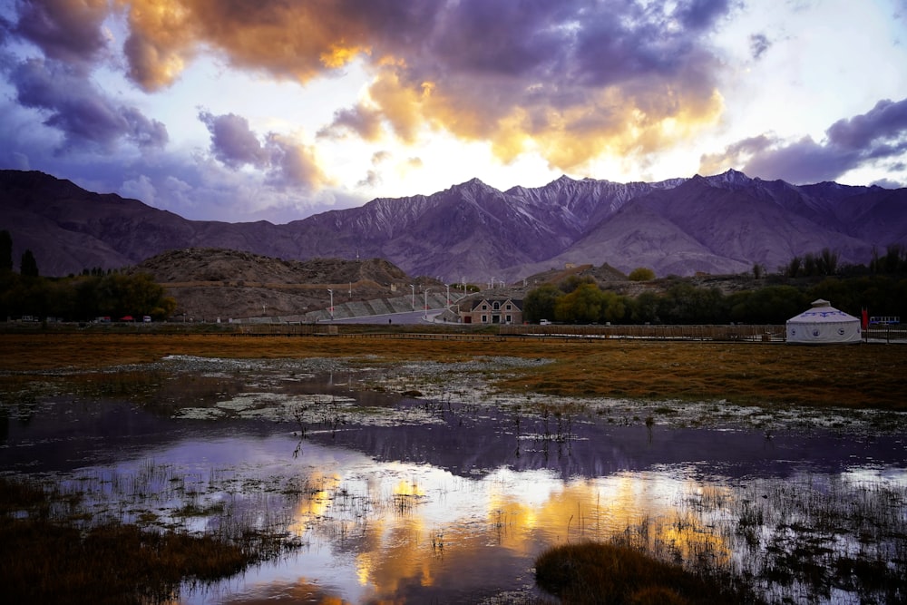 a large body of water with mountains in the background