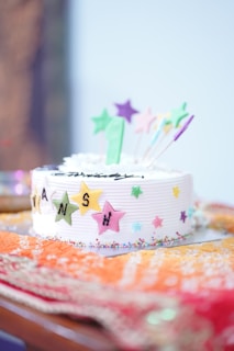 A vibrant birthday cake decorated with colorful frosting and sprinkles.