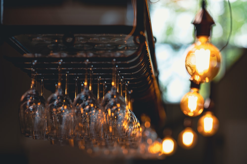 a bunch of wine glasses that are hanging from a rack