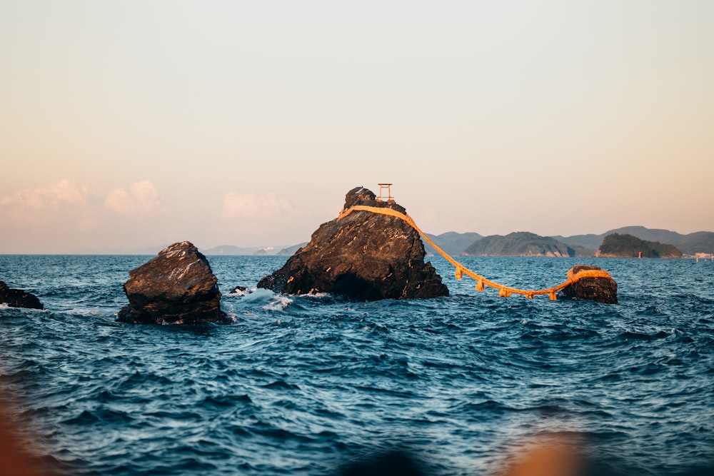 a rock in the middle of a body of water