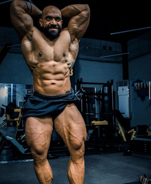 Before and after images of a client showing impressive muscle definition in a sleek gym setting.