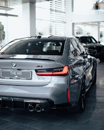 a silver car is parked in a showroom