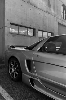 a silver sports car parked in front of a building