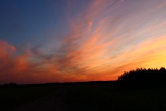 Sunset view over the Taj Mahal with vibrant orange and pink skies.