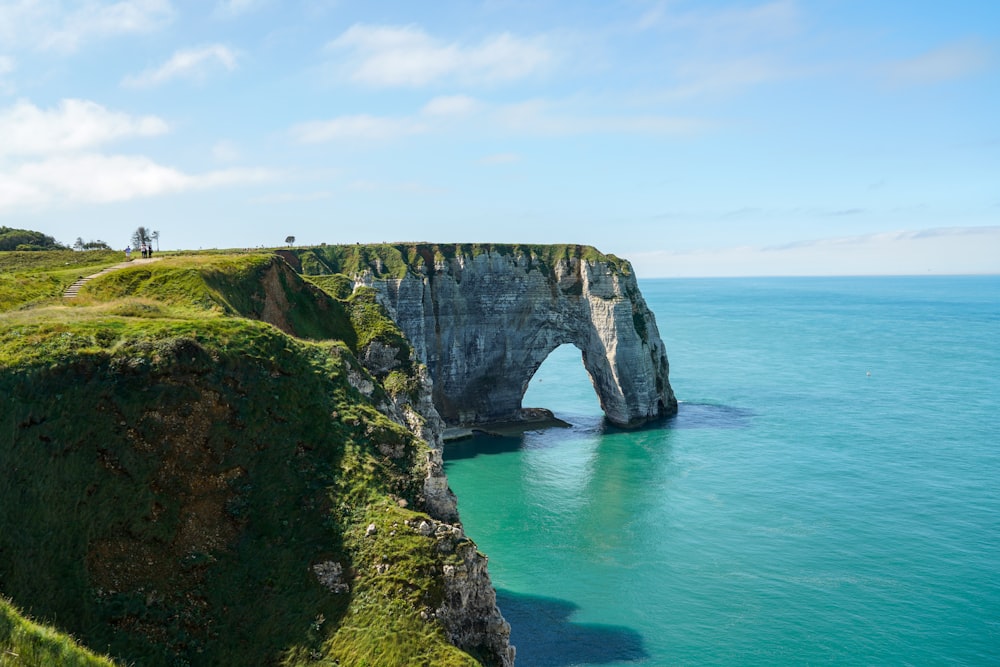 a large rock formation in the middle of a body of water