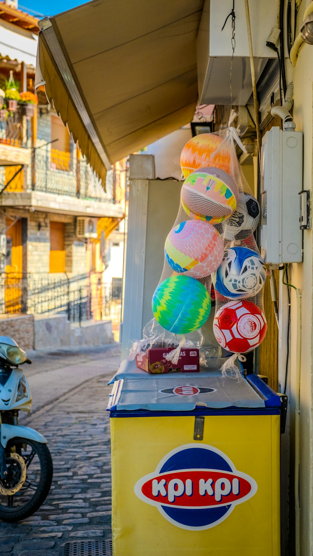 a yellow kiosk with a bunch of stuffed animals on top of it