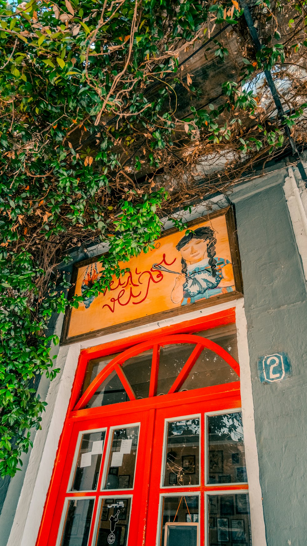 a building with a red door and a sign above it