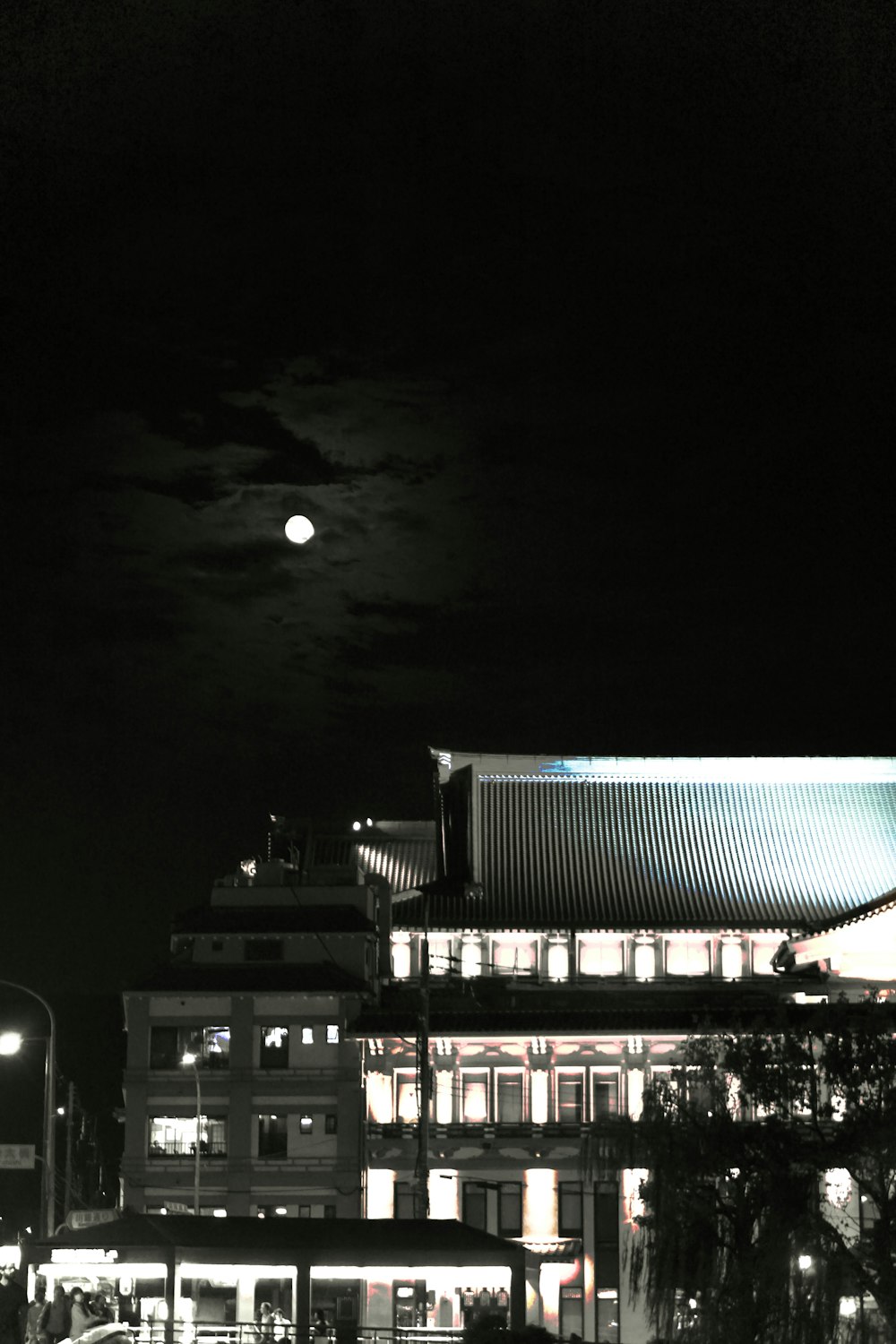 a building with a full moon in the background