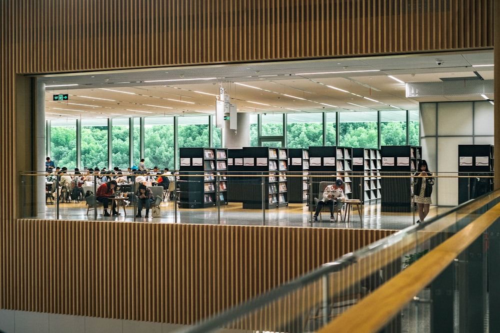 a group of people sitting at tables in a library