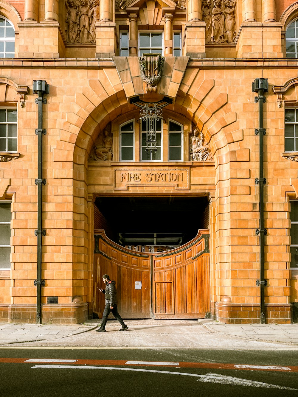 a man walking in front of a large building