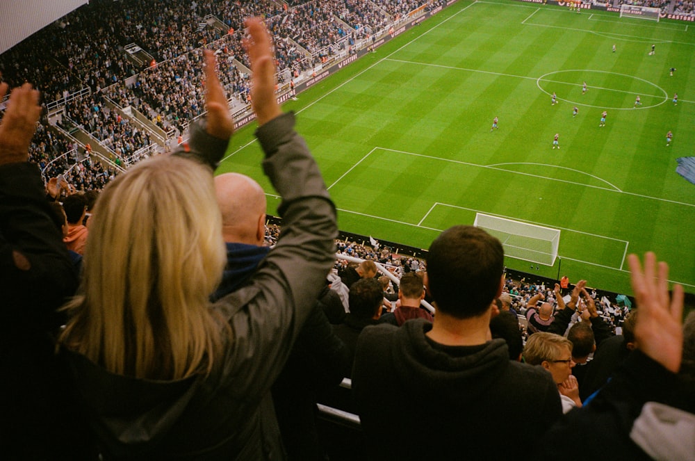 a crowd of people watching a soccer game