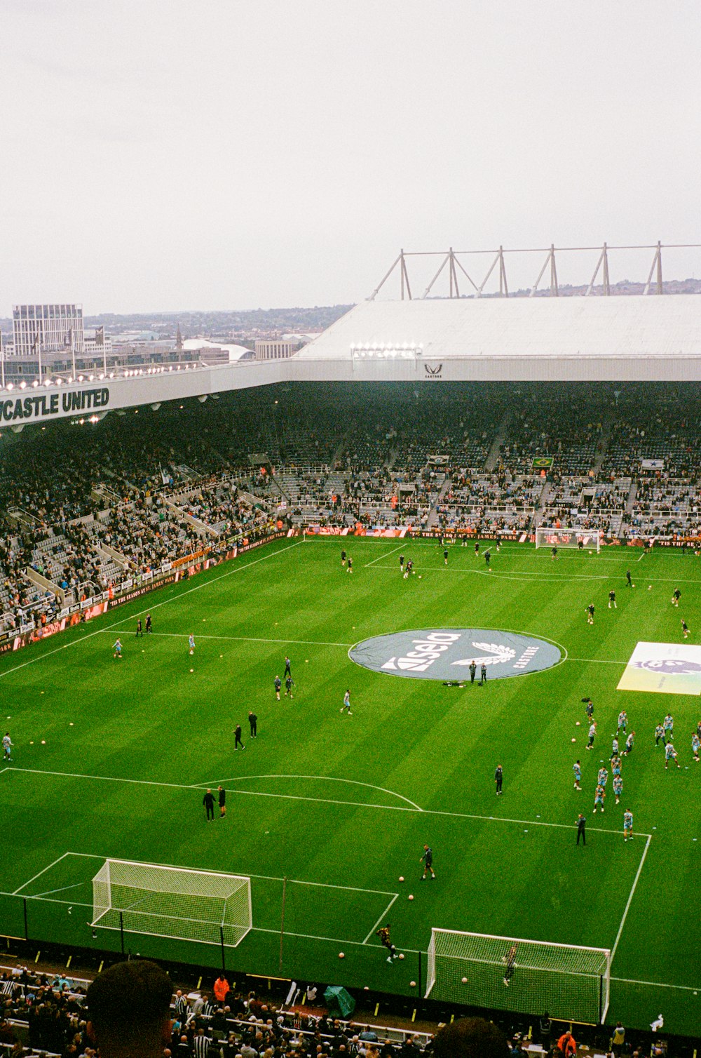 a soccer field with a large crowd of people