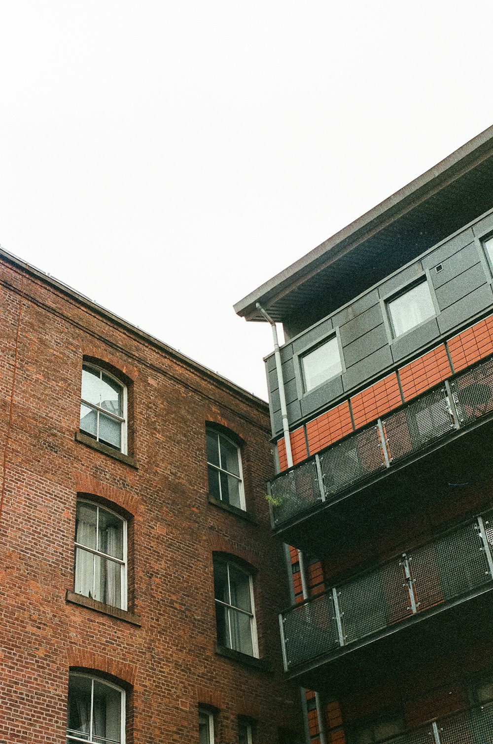 a tall brick building with a clock on the side of it