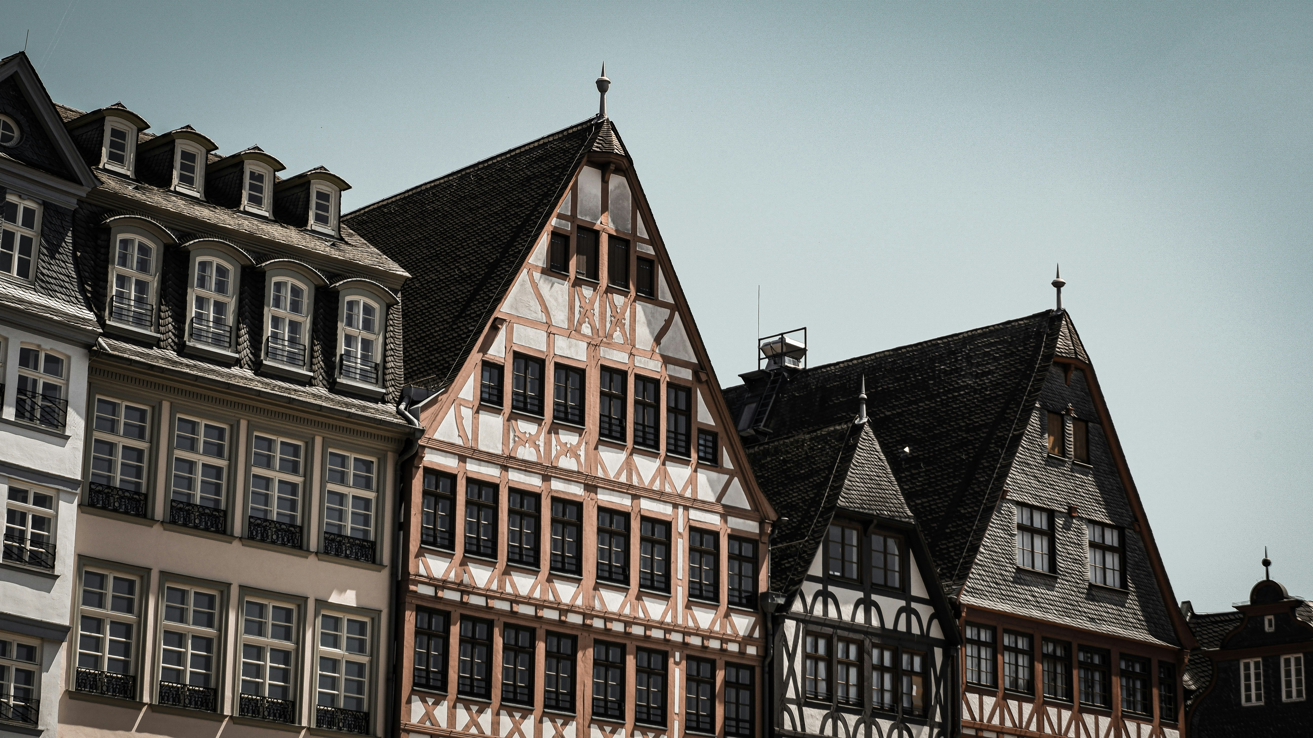 a row of buildings with a clock on each of them
