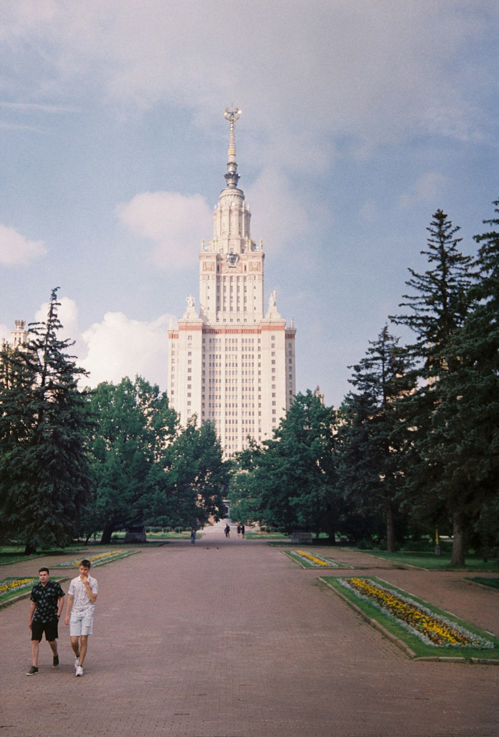 a couple of people standing in front of a tall building