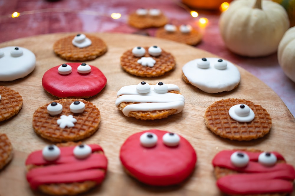 a wooden plate topped with cookies covered in icing