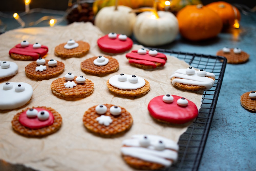 a table topped with lots of cookies covered in icing