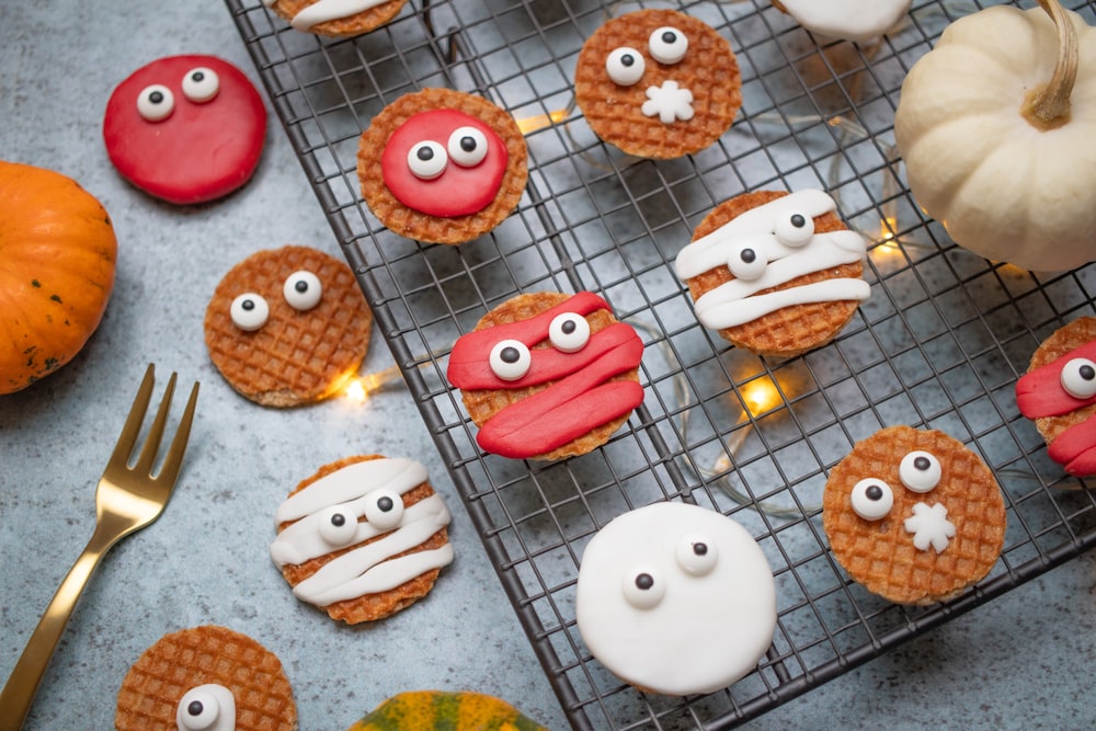 a table topped with lots of cookies covered in icing