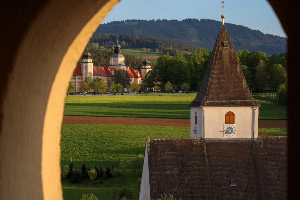 a view of a church from a window in a building