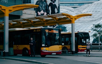 A modern bus parked at a city bus station.