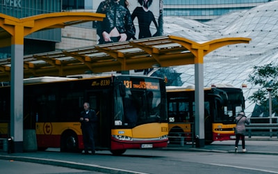 A busy bus station with travelers boarding a modern bus.