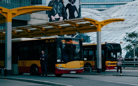A modern bus parked at a city bus station.