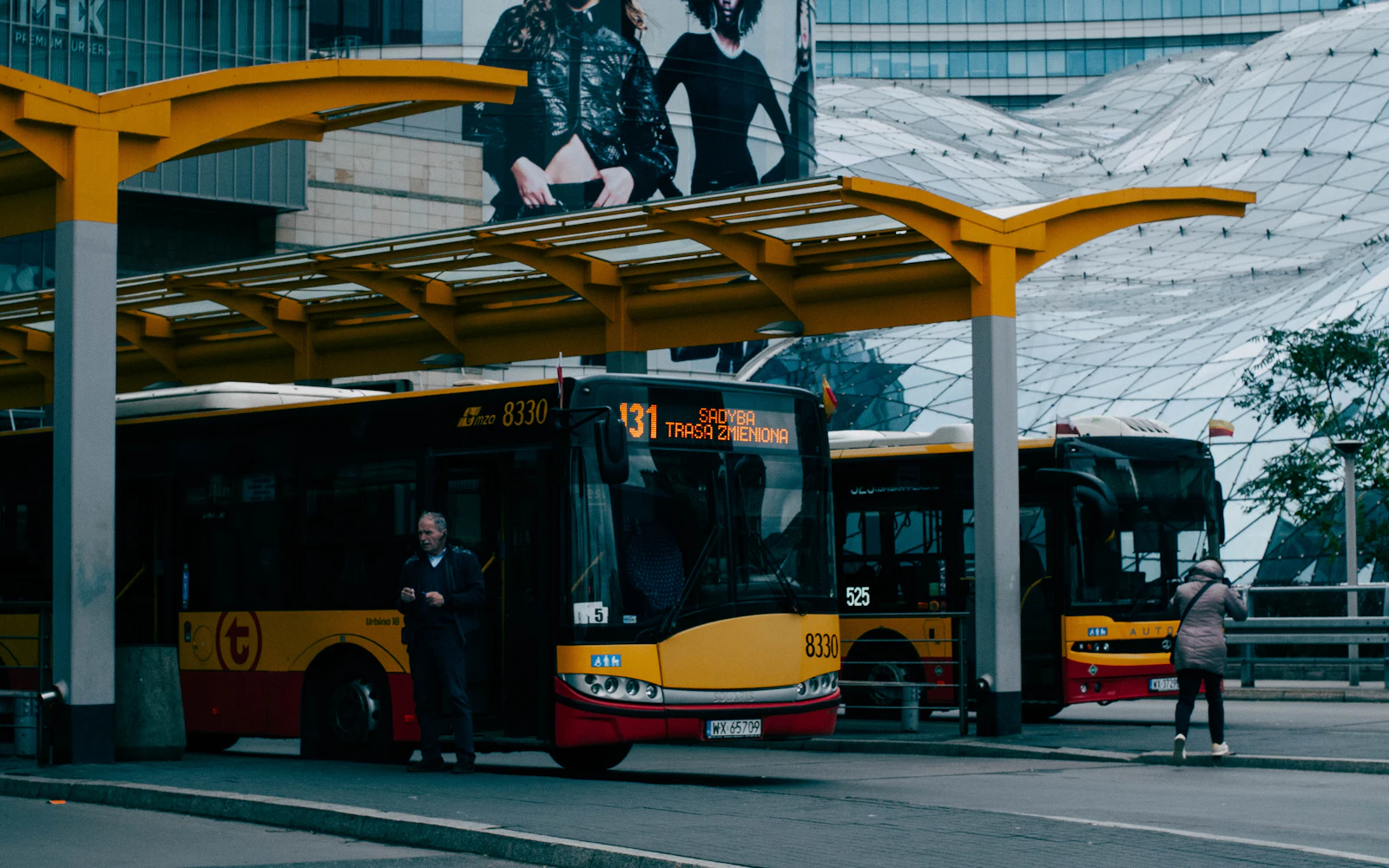 Two buses parked side by side at the end of a route