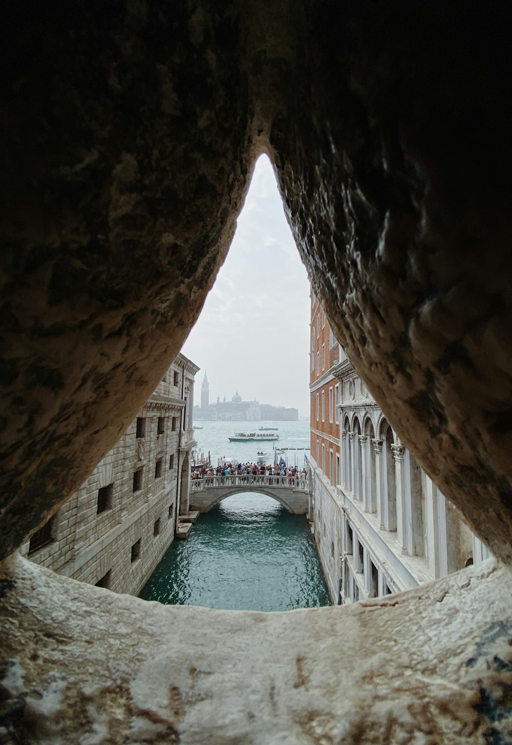 a view of a canal from inside a tunnel