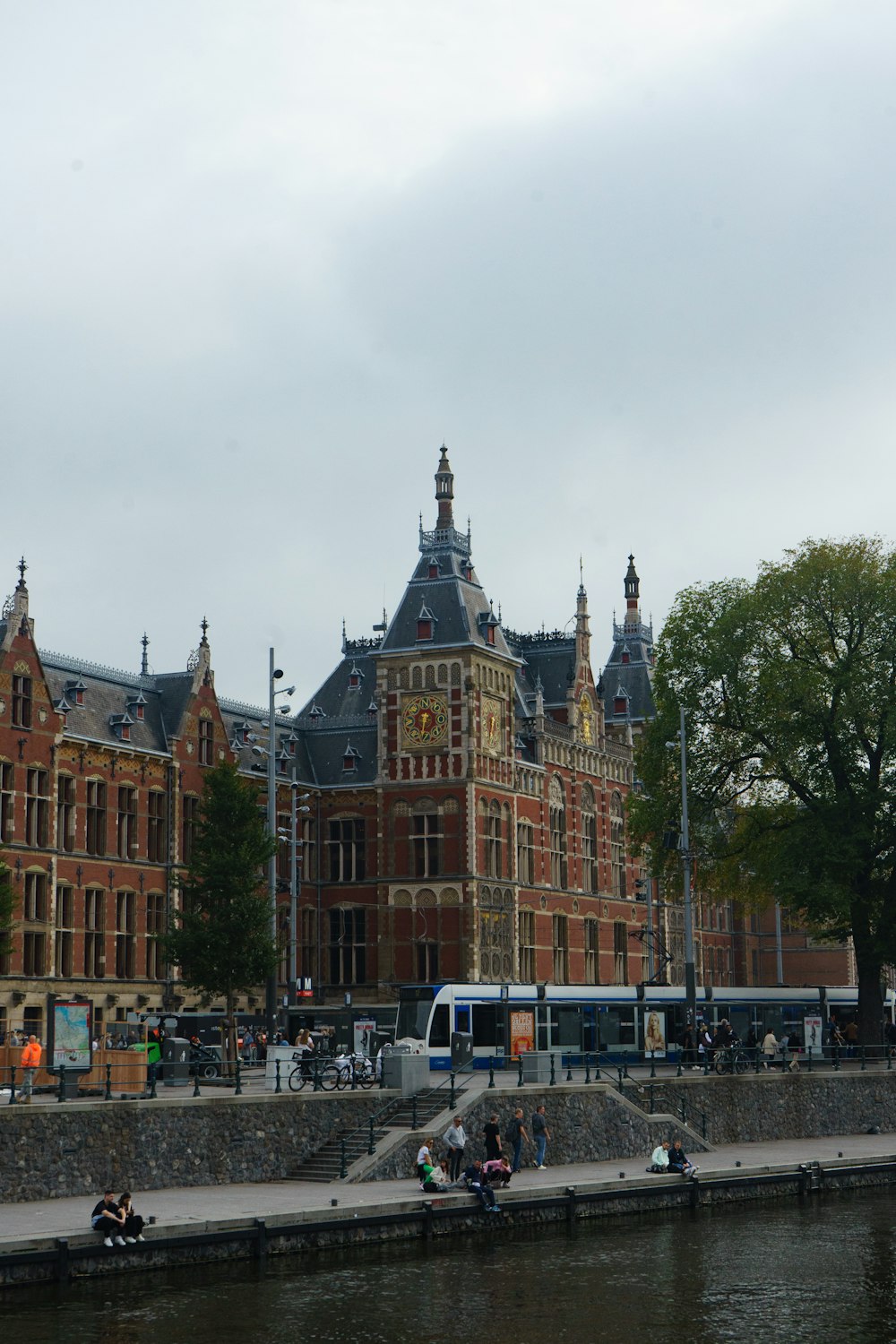 a large brick building next to a body of water