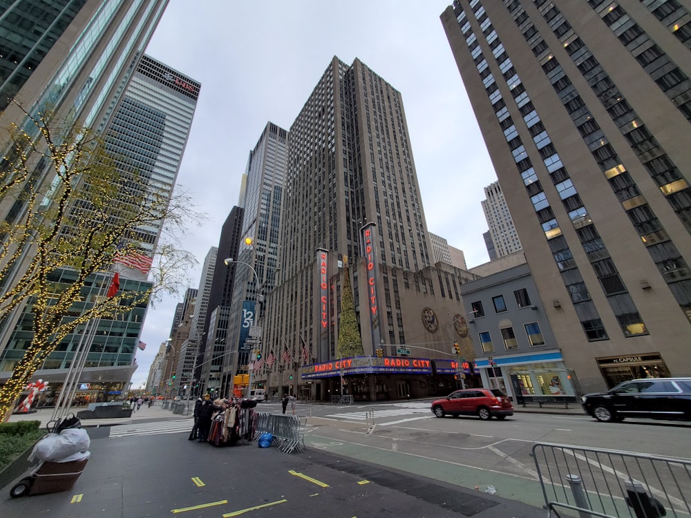 a city street with tall buildings in the background