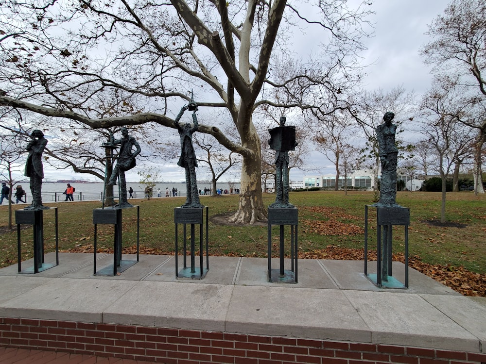 a group of sculptures sitting on top of a cement slab