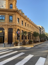 a yellow building with a clock on the top of it