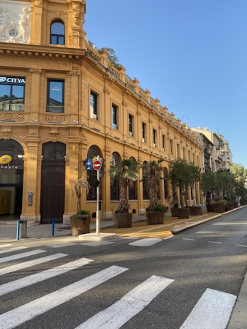 a yellow building with a clock on the top of it