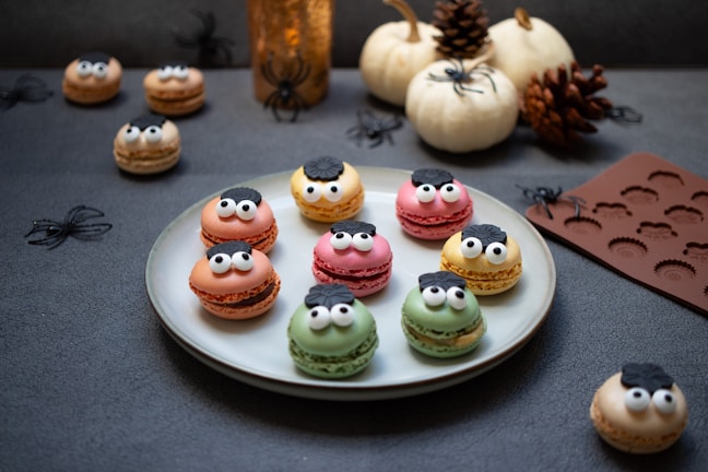 a white plate topped with macaroons covered in frosting