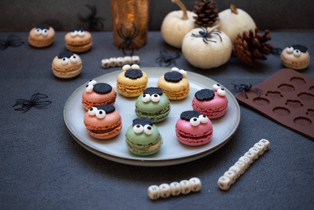 a white plate topped with macaroons covered in frosting