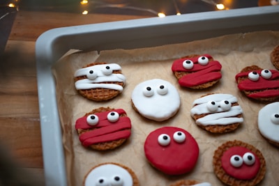 a tray of decorated cookies with googly eyes