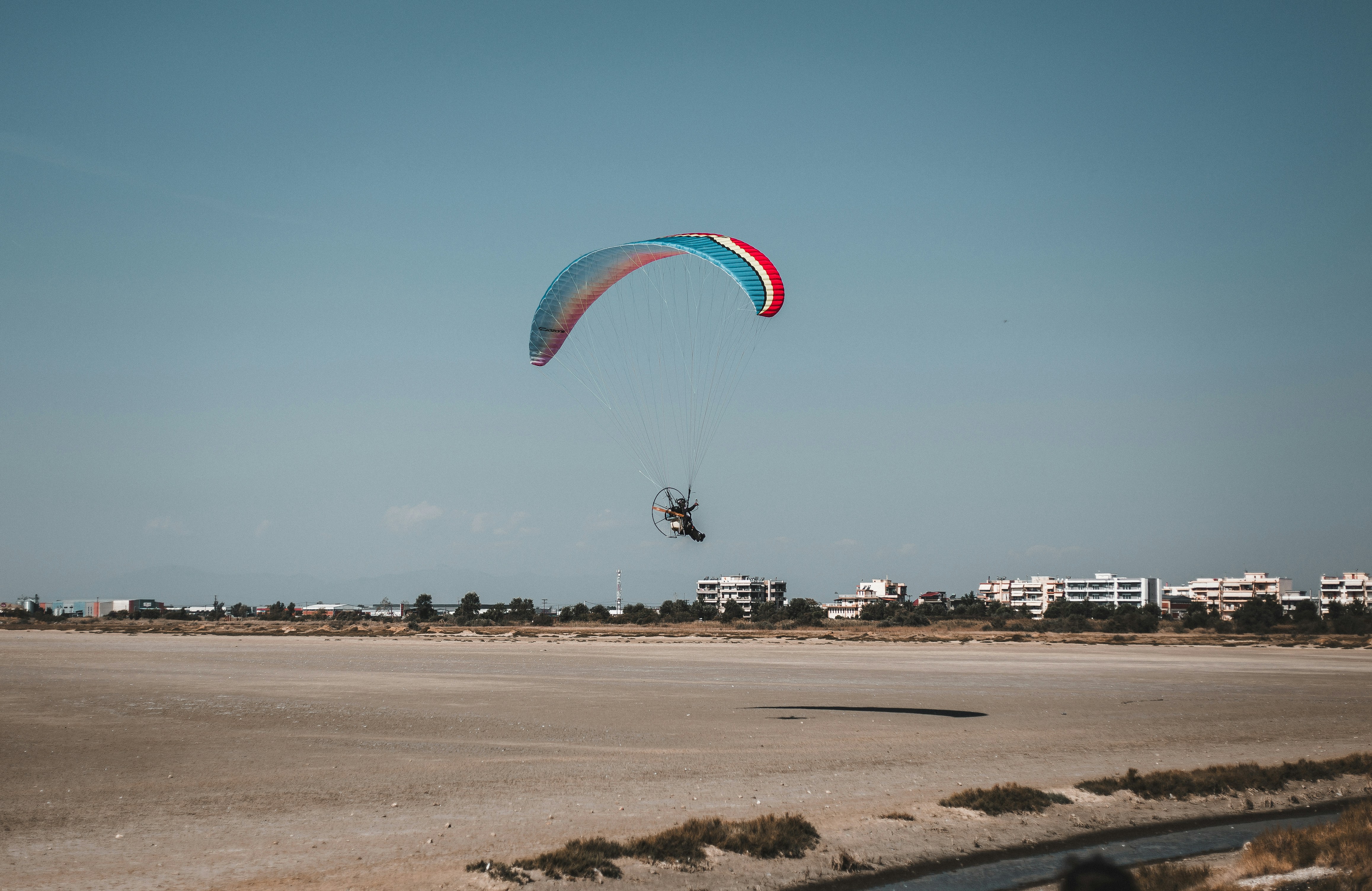 a person is parasailing in the middle of the desert