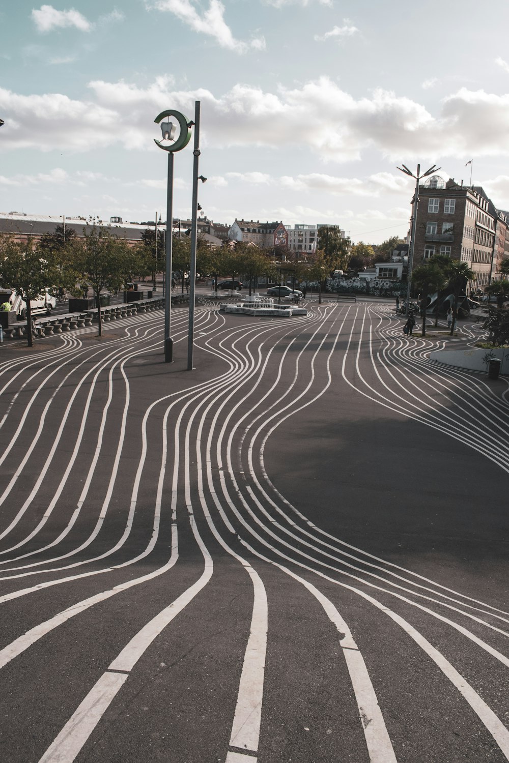 a curved road with a clock tower in the background