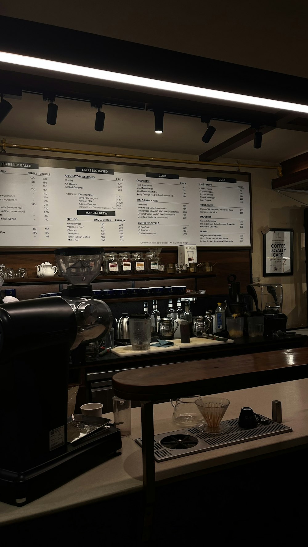 a coffee shop with a menu on the wall