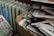 a cardboard box full of newspapers next to a radiator