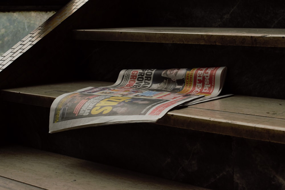 a newspaper laying on the ground next to some stairs