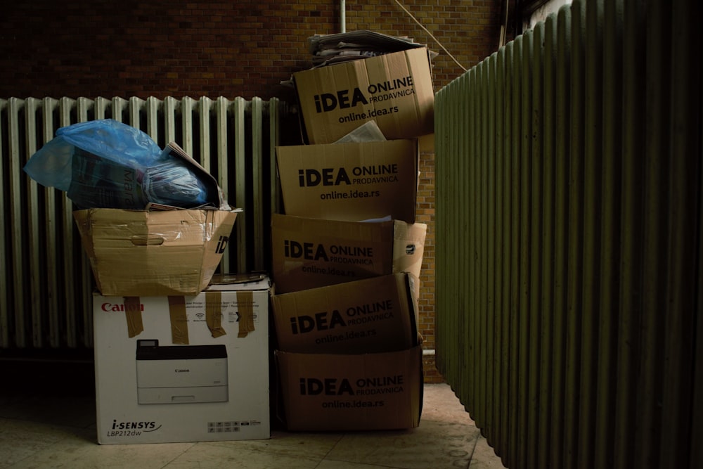 a pile of boxes sitting next to a radiator